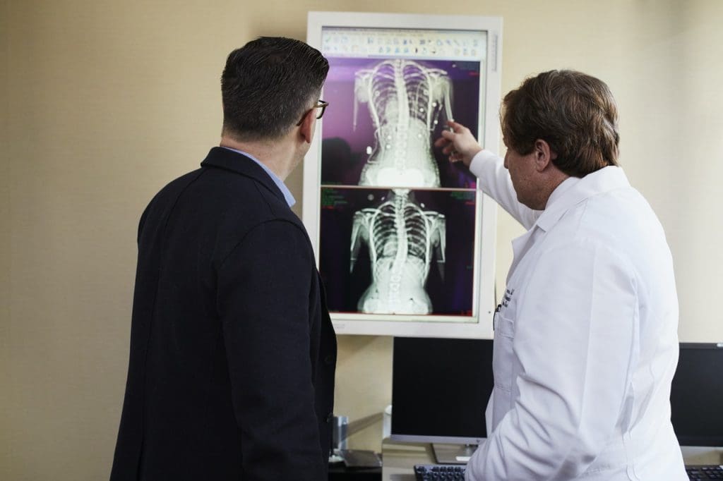 Doctor Pointing X-ray Result