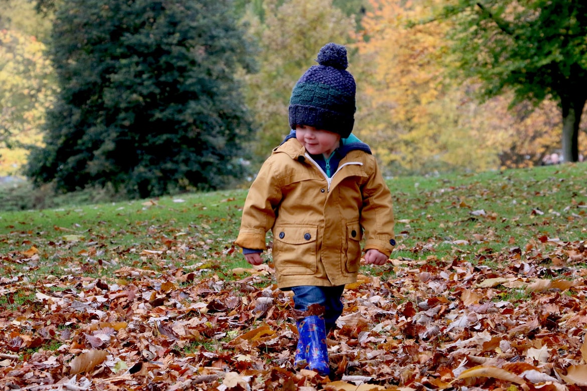kid walking in leaves